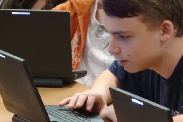 a student works on a chromebook.