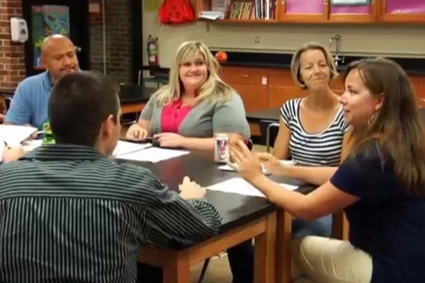 A group of teachers engage in a Professional Learning Community.